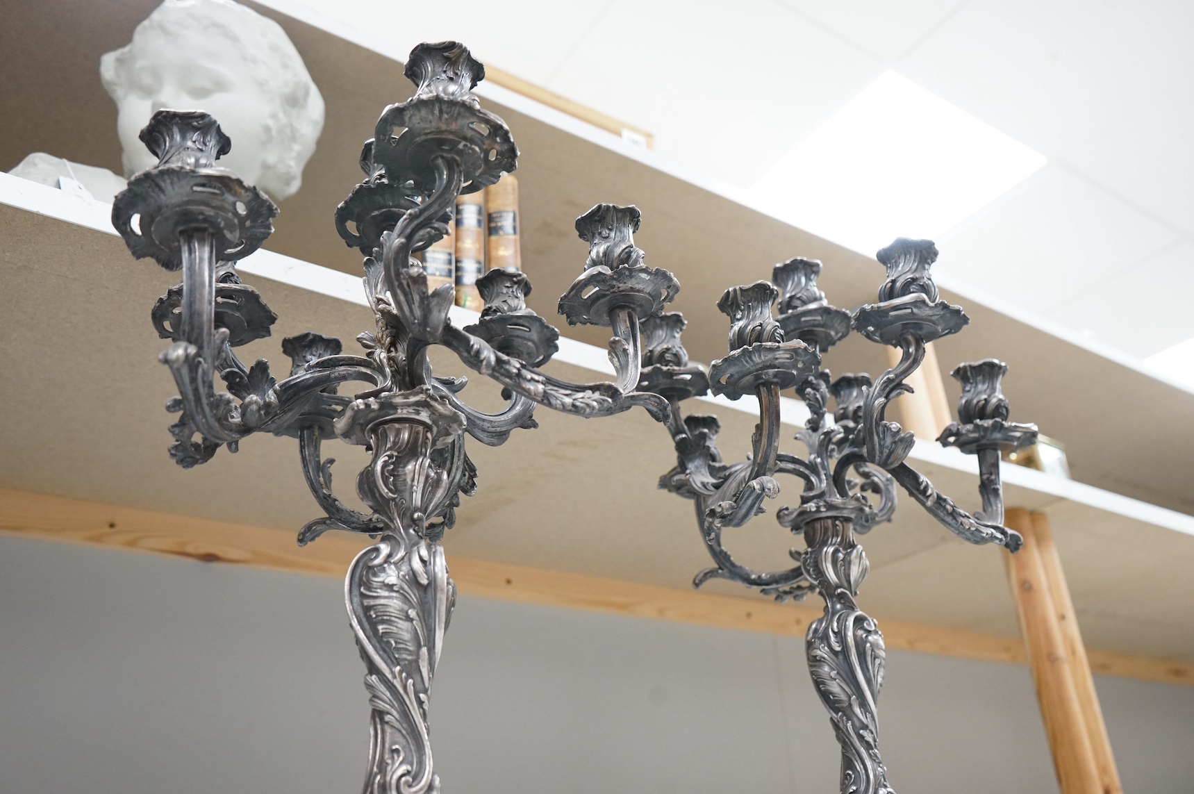 A pair of silver plated Rococo style six branch, seven light candelabra, 49cm. Condition - fair to good